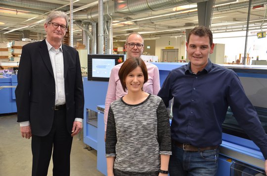 From right: Raphael Kacimi, machine operator, Judith Wilhelm, Thomas Freitag and Richard Hofer (Sales Director at Muller Martini Switzerland) standing in front of the Vareo at Bubu.